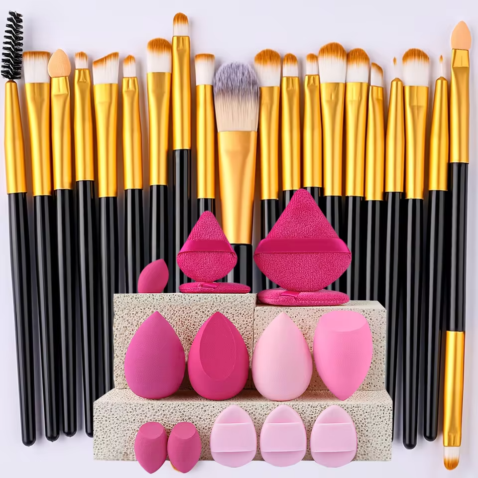 Zentheca Makeup Brush & Sponge Set featuring gold-handled brushes and pink blending sponges for flawless makeup application.