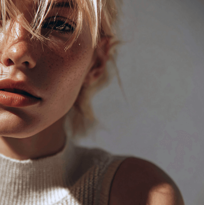 Close-up of a model with fresh skin and subtle makeup, promoting beauty and skincare with Herbal Recovery Lotion.