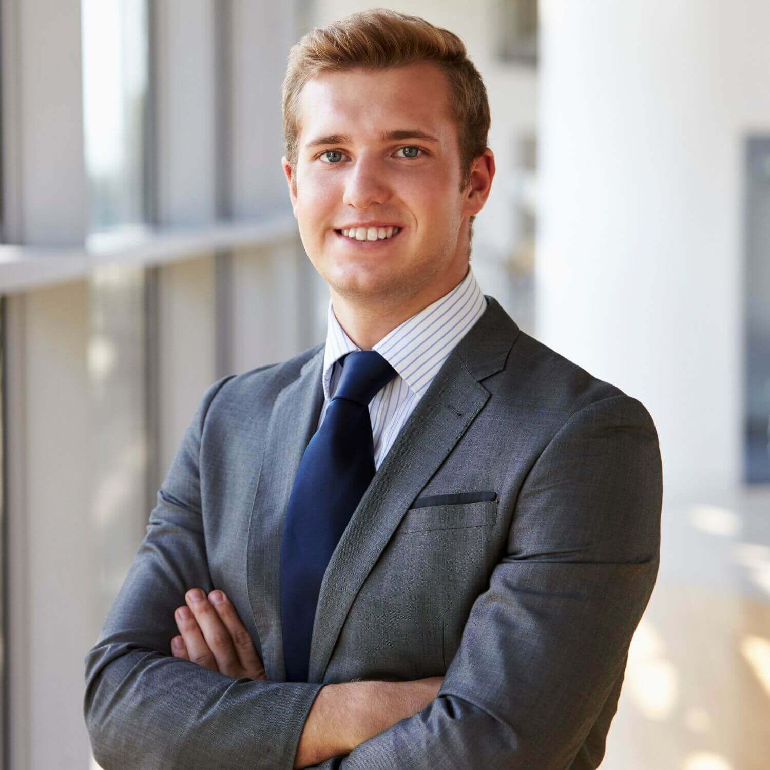 Portrait of a professional man in a suit smiling confidently, showcasing a polished and approachable demeanor.