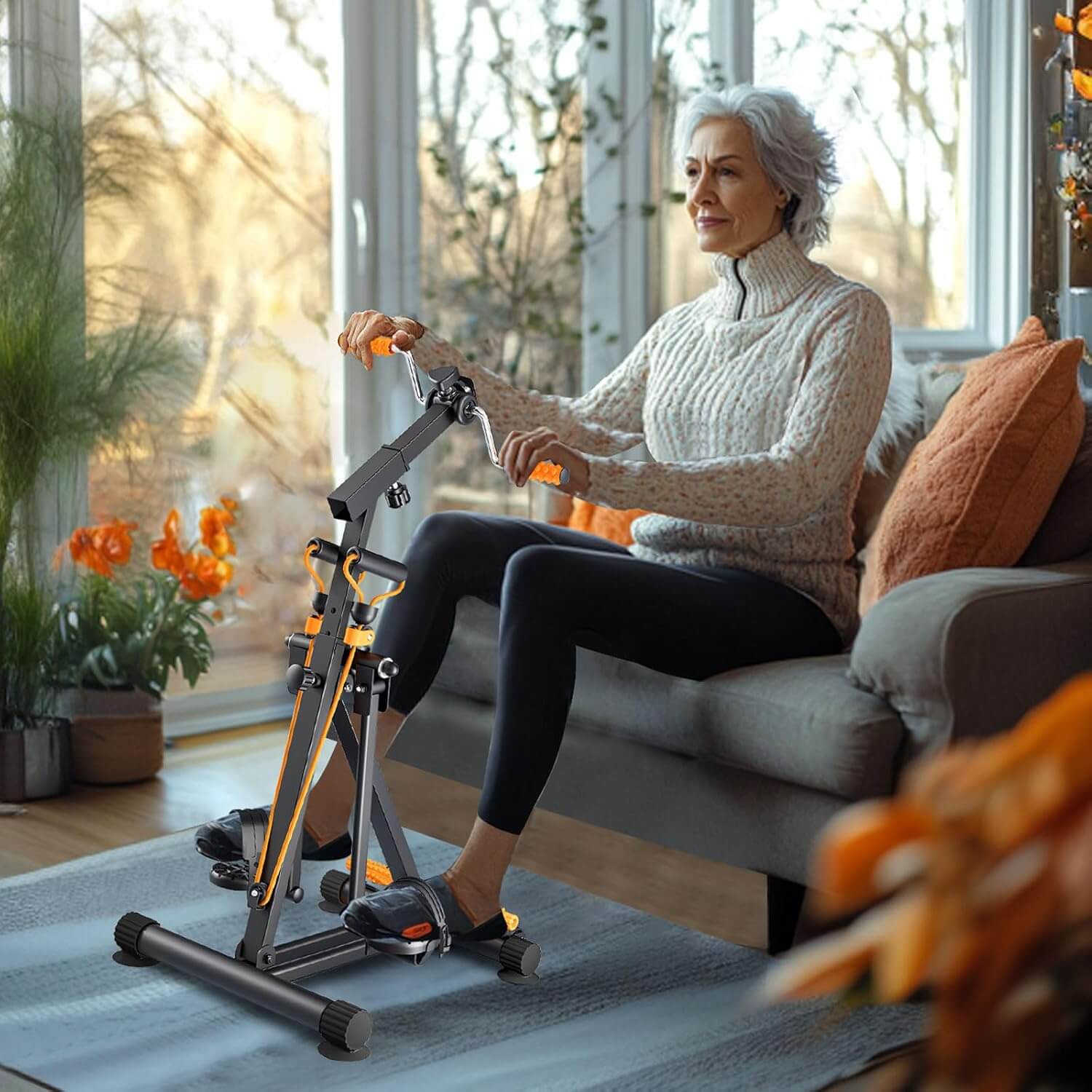 A senior woman uses the Zentheca FlowCycle™ pedal trainer in a cozy living room for wellness and fitness.