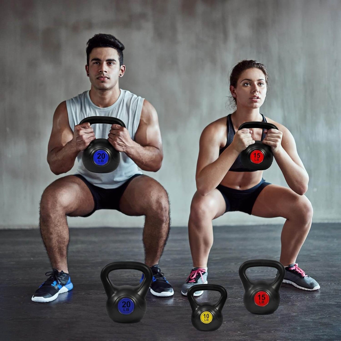 Zentheca PowerBell™ kettlebells used by two athletes performing squats in a gym setting.