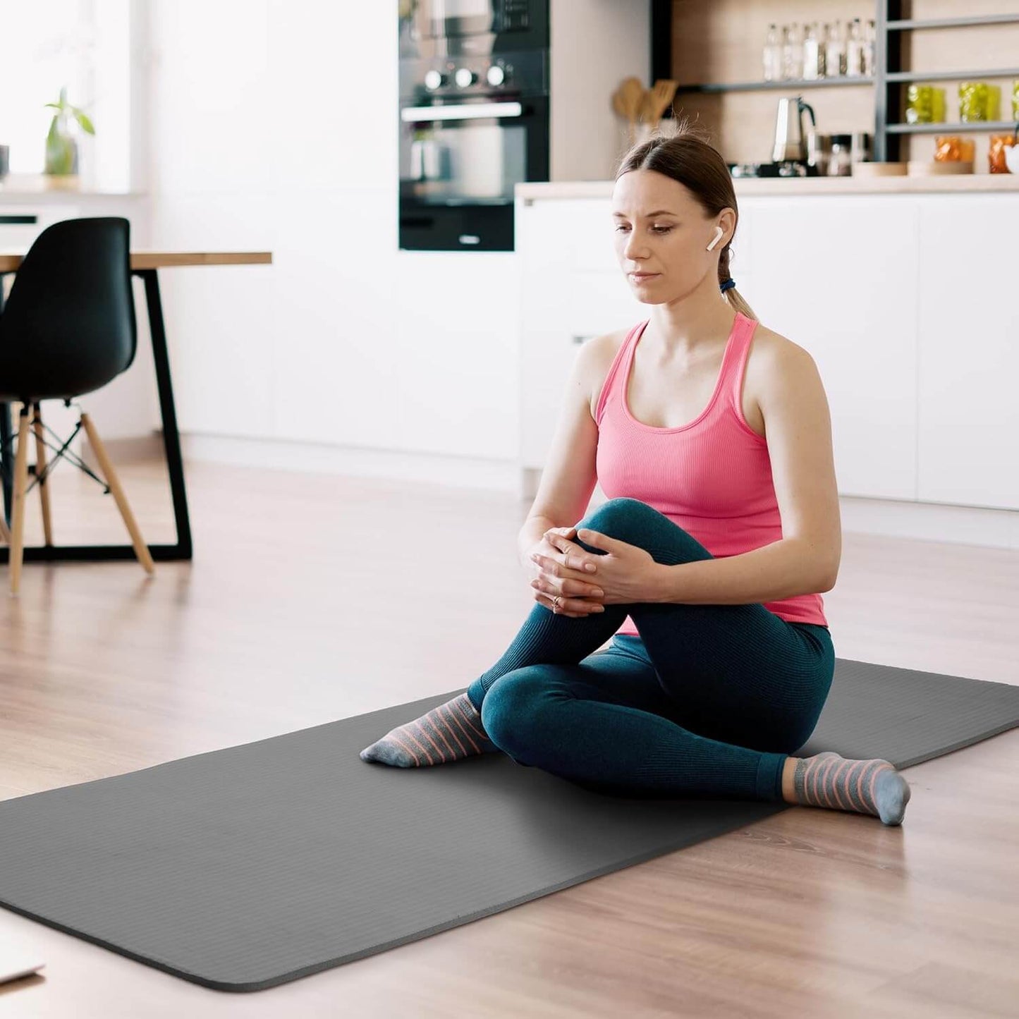 Zentheca BalanceMat in use by a woman practicing yoga in a modern home setting.